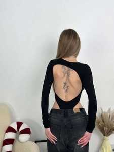 Detail of sexy black long sleeve bodysuit with U-shape open back and ribbed texture