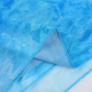 Close-up of tie-dye blue mesh fabric with fine net texture and durable double-stitched hem