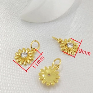 Macro shot of 14K gold-plated daisy charms with zircon inlay and 11x9mm size details