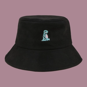 Close-up of small green dinosaur embroidery on a black cotton bucket hat