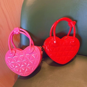 Close-up of pink and red heart-shaped PVC jelly bags with quilted diamond pattern