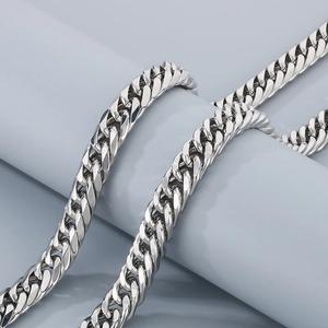 Polished silver stainless steel double woven Cuban link bracelet for men on display