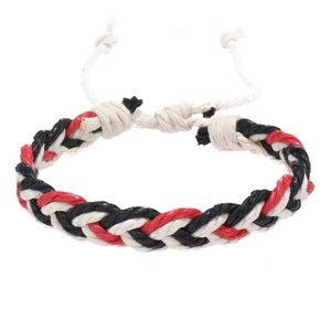 Detail of red black and white braided cotton rope bracelet with adjustable knot design