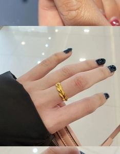 Close-up of 18K gold plated bow and wheat leaf textured ring worn on the index finger