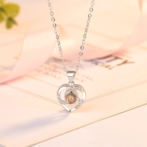 Silver projection heart necklace with round center stone and sparkling zircon accents