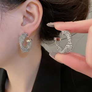 Silver plated twisted C-shaped stud earrings with industrial wire wrapped design for women