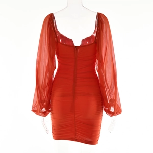 Detail of red V-neck dress with ruched texture, backless design and sheer puff sleeves