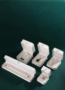 White PU leather jewelry box set featuring gold crown logo and elegant velvet lining