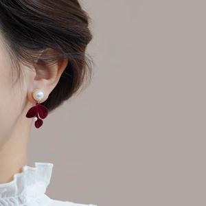 Elegant long fringe drop earrings with red flocked leaves and pearls on model