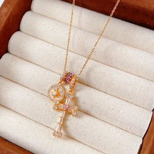 Close-up of 18k gold plated cross pendant with zircons and mother of pearl on jewelry box