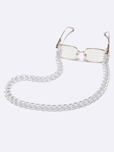 Transparent acrylic eyewear chain with gold metal frame glasses on white background