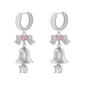 Close-up of silver ribbon earrings with pink heart zircon and starry bell detail