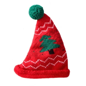 Mini knitted red Christmas hat with green pompom and tree pattern for holiday decor
