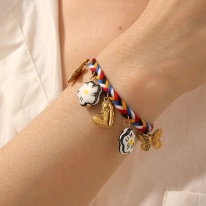 Colorful woven rope bracelet with ceramic floral charms and gold-plated heart butterfly