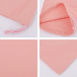 Detail view of pink cotton drawstring bag showing stitching, texture, and interior lining