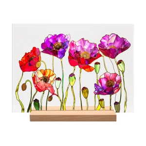 Macro detail of acrylic floral desk decor with poppy print and wooden base