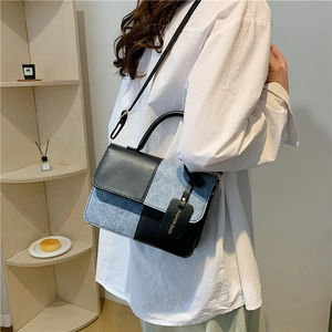 Minimalist square crossbody bag featuring color-block black leather and blue denim texture