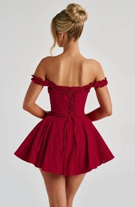 Detailed back view of dark red lace mini dress with off-shoulder and lace-up corset design