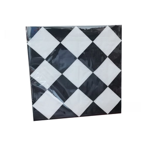 Detail of square racing theme napkins with black and white checkered pattern in bulk packaging