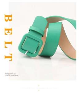 Detail of mint green leather belt with matching square buckle on white background