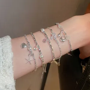 Eleganti bracciali a strati con perle, ciondoli a cuore e pendenti a stella per donna