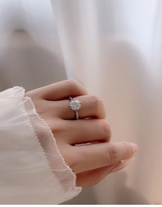 Macro side view of a sparkling round halo moissanite ring in S925 sterling silver