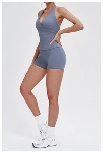 Detailed side view of blue-grey brushed yoga set with cross back top and high waist shorts