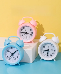 Retro quartz alarm clocks in pink, blue and white with metal twin bells for loud ringing