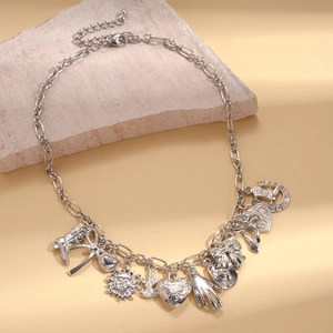 Detailed close-up of a silver charm necklace with cowboy boots and sun pendants