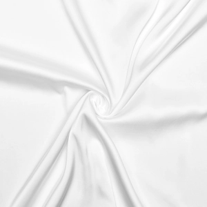 Close-up of white silk fabric showing smooth texture and glossy luster of the dress