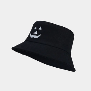 Side view of black Halloween bucket hat with a white glowing pumpkin face print