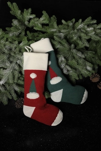 Detailed knit texture of red and green Christmas stockings with festive tree patterns