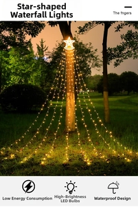 Outdoor LED star waterfall lights with warm white glow hanging on garden trees at night
