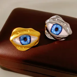 Irregular resin eye open rings in gold and silver finish on a premium leather jewelry box