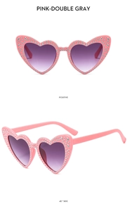 Detailed views of pink heart-shaped sunglasses with rhinestones and purple gradient lenses