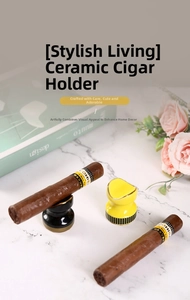 Ceramic cigar rest with gold trim on marble surface showing portable elegant holder