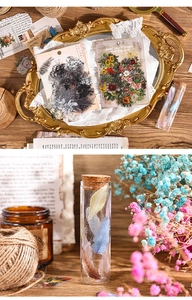 Detail of vintage nature stickers with floral patterns and feather bottle on wood