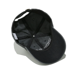 Detailed interior of vintage cotton cap showing 100% cotton label and metal buckle