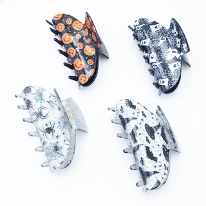 Set of four acrylic Halloween hair claws with pumpkin, ghost, spider, and bat designs