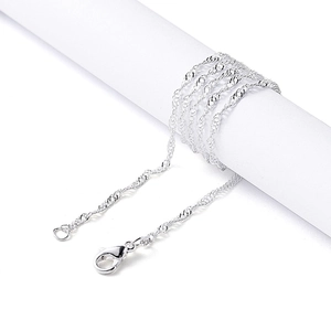 Detailed view of silver water wave chain with lobster clasp on a white display