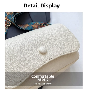 Detail of creamy white crossbody bag featuring lychee grain leather and a matching buckle