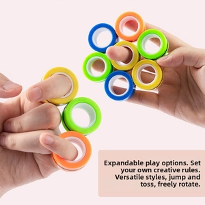 Vibrant magnetic fidget rings in multiple colors being rotated on fingers for stress relief