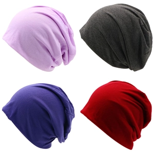 Detail view of slouchy knit beanies in light purple, dark grey, deep purple, and red colors