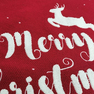 Red knitted Christmas tree skirt featuring white 3D reindeer embroidery and snowflakes
