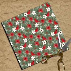 Christmas scrapbook paper featuring cardinals and floral patterns with metal scissors