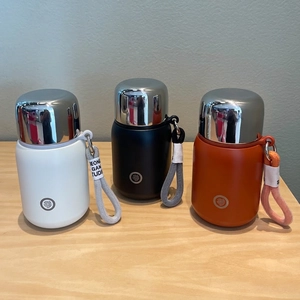 316 stainless steel vacuum insulated bottles in black white and orange with woven straps