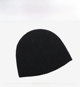 Detail view of the ribbed knit texture and black fabric of the winter beanie hat