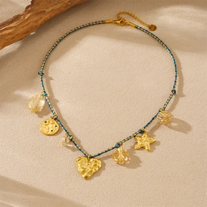 Detail of gold-plated stainless steel clasp with S.STEEL hallmark and colorful cord