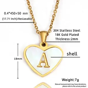 Macro shot of 18K gold plated heart pendant with letter A and white shell inlay detail