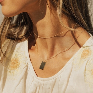 Double-layered 316L stainless steel gold necklace with rectangular pendant on model